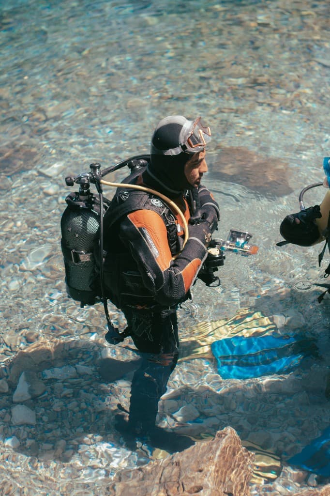 Diver standing waist-deep in kit