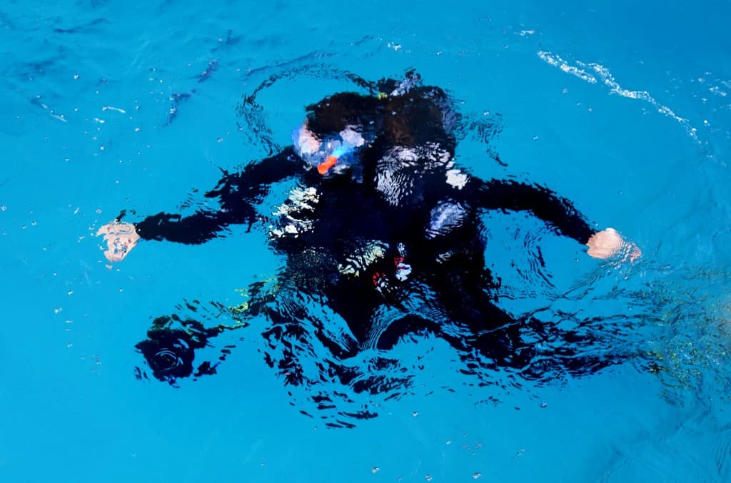 Diver just below the surface of the training pool