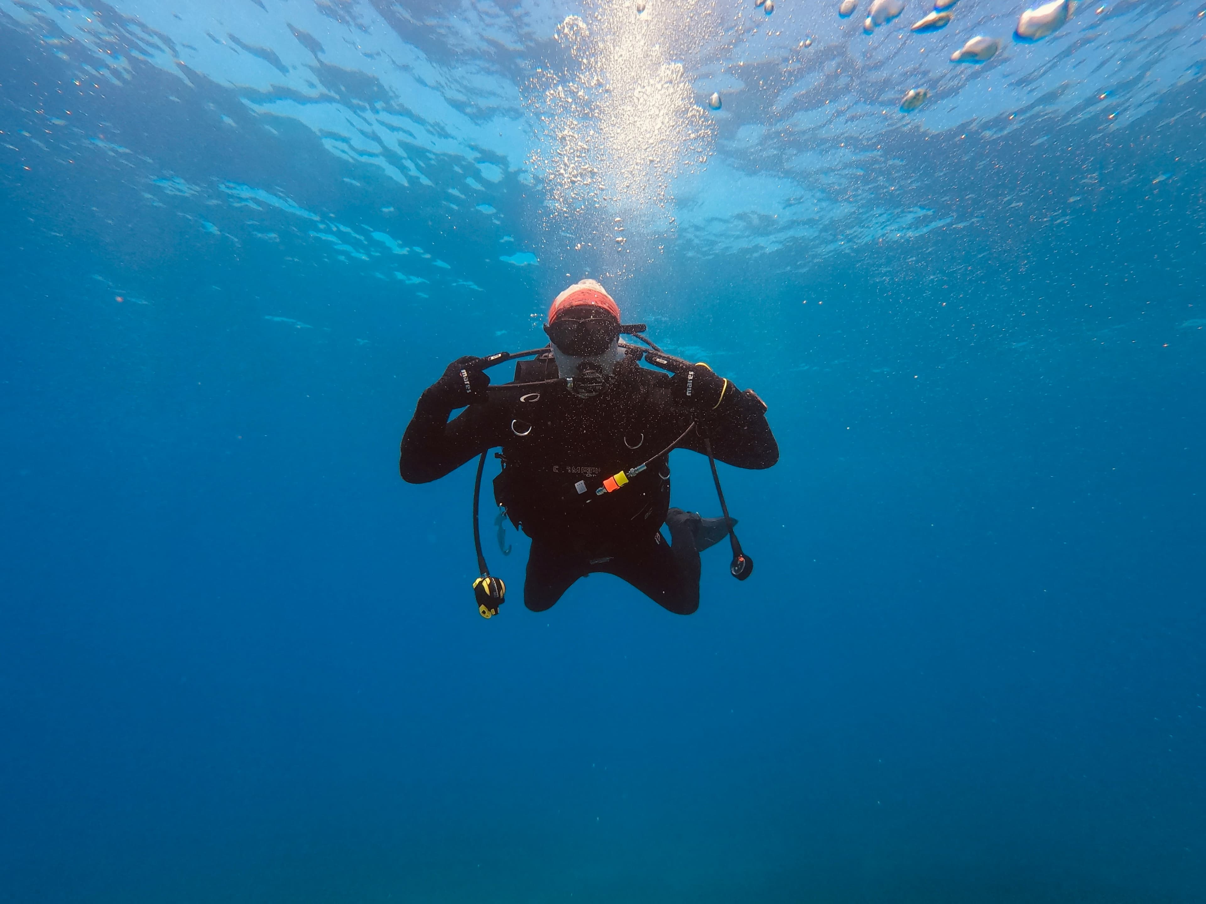 Diver facing camera in open blue water