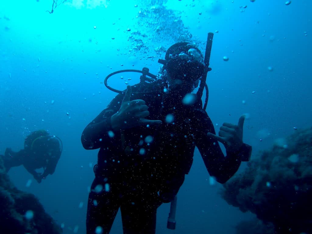 Diver making a shaka sign in blue water