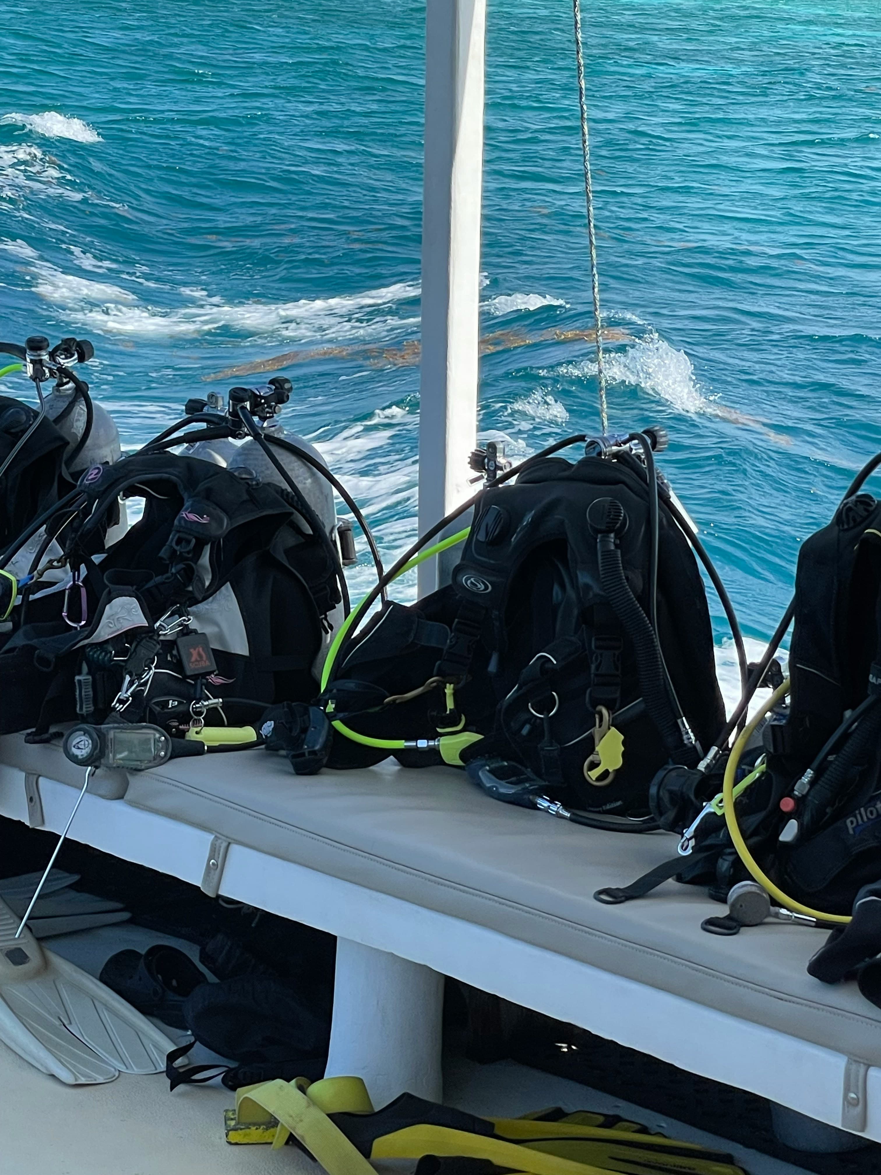 BCD kits lined up on a dive boat