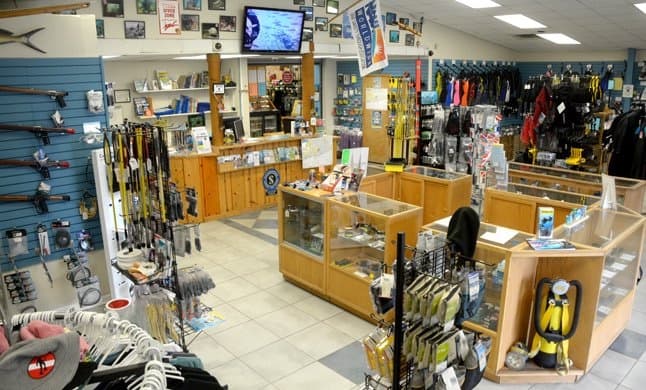 Retail floor at Dive Pros: cases, slatwall, and the service counter